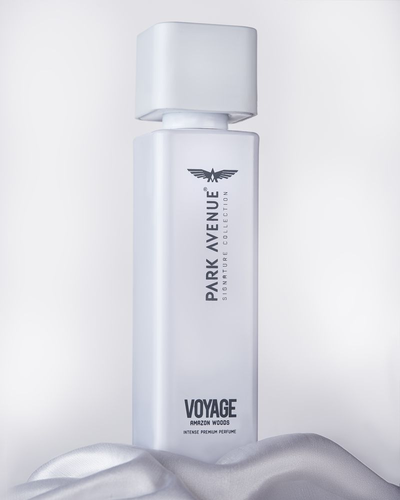 Park Avenue Voyage Amazon Woods perfume bottle styled on white fabric in a high-key studio setup